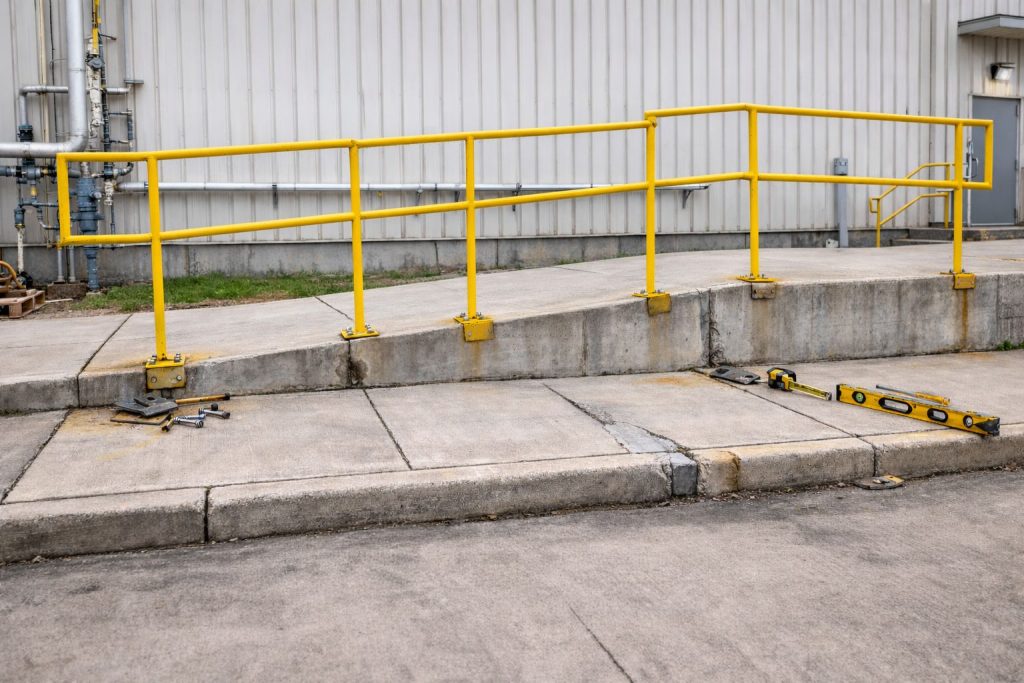 A poorly installed walkway railing, demonstrating that pre-fabricated parts may not always fit well into an existing facility.